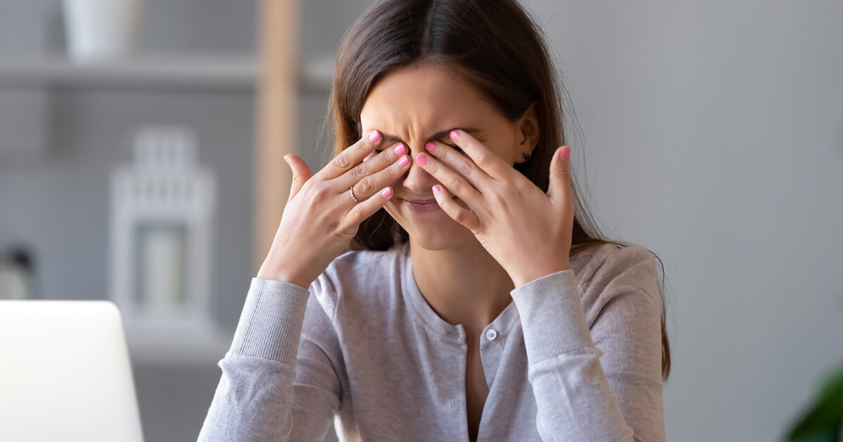 Woman rubbing her eyes because of dry eye